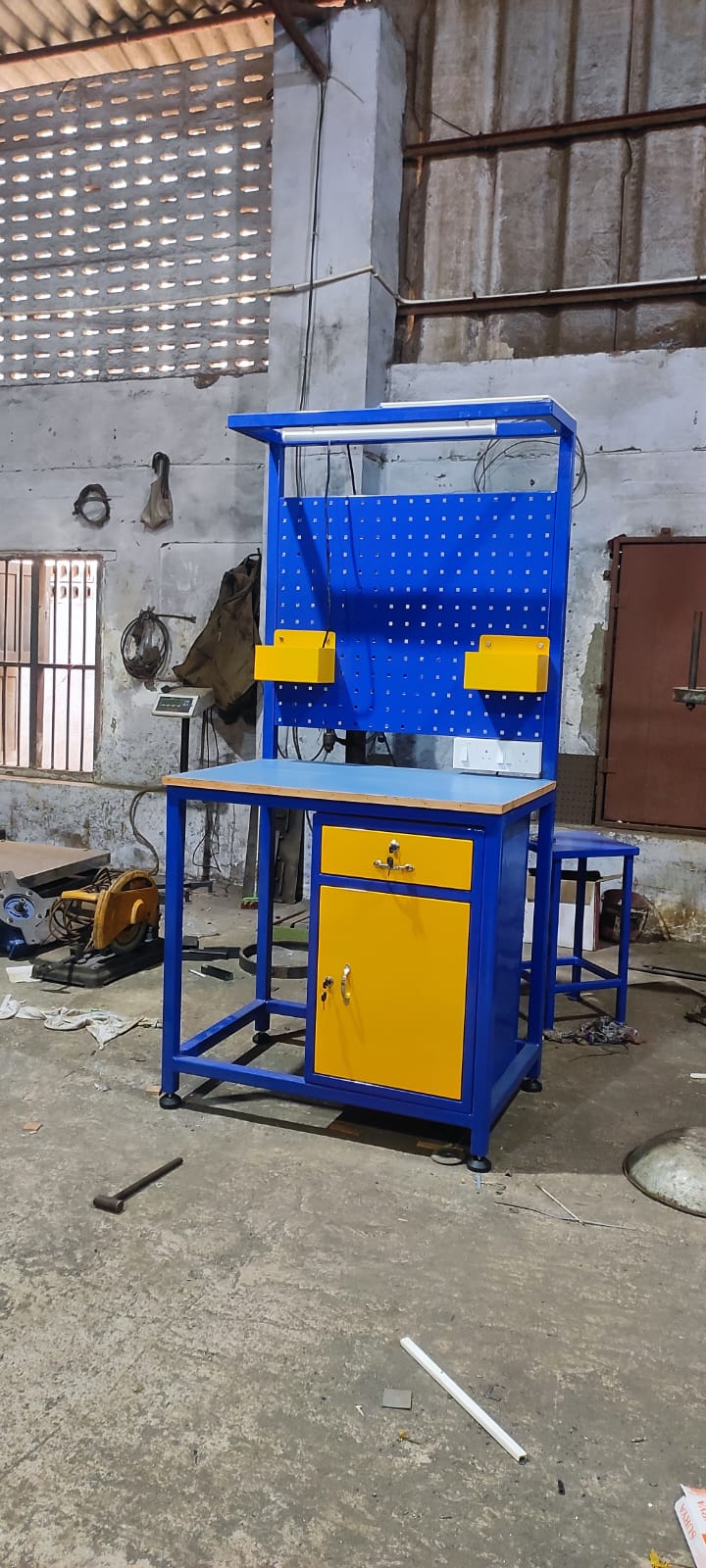 Blue inspection table with tool board and cabinet